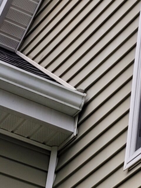 We use rain diverters to prevent water from getting between wall and end of gutter. - 